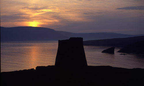 Mousa Broch at sunset with the North Sea and the Shetlands in the background